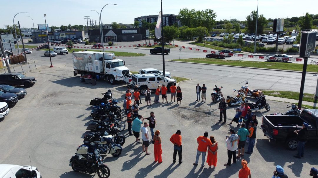 Group gathered in circle at Every Child Matters Motorcycle Ride