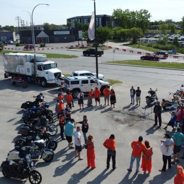 Group gathered in circle at Every Child Matters Motorcycle Ride